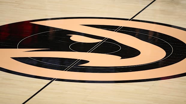 Black and peach Hawks logo at midcourt.